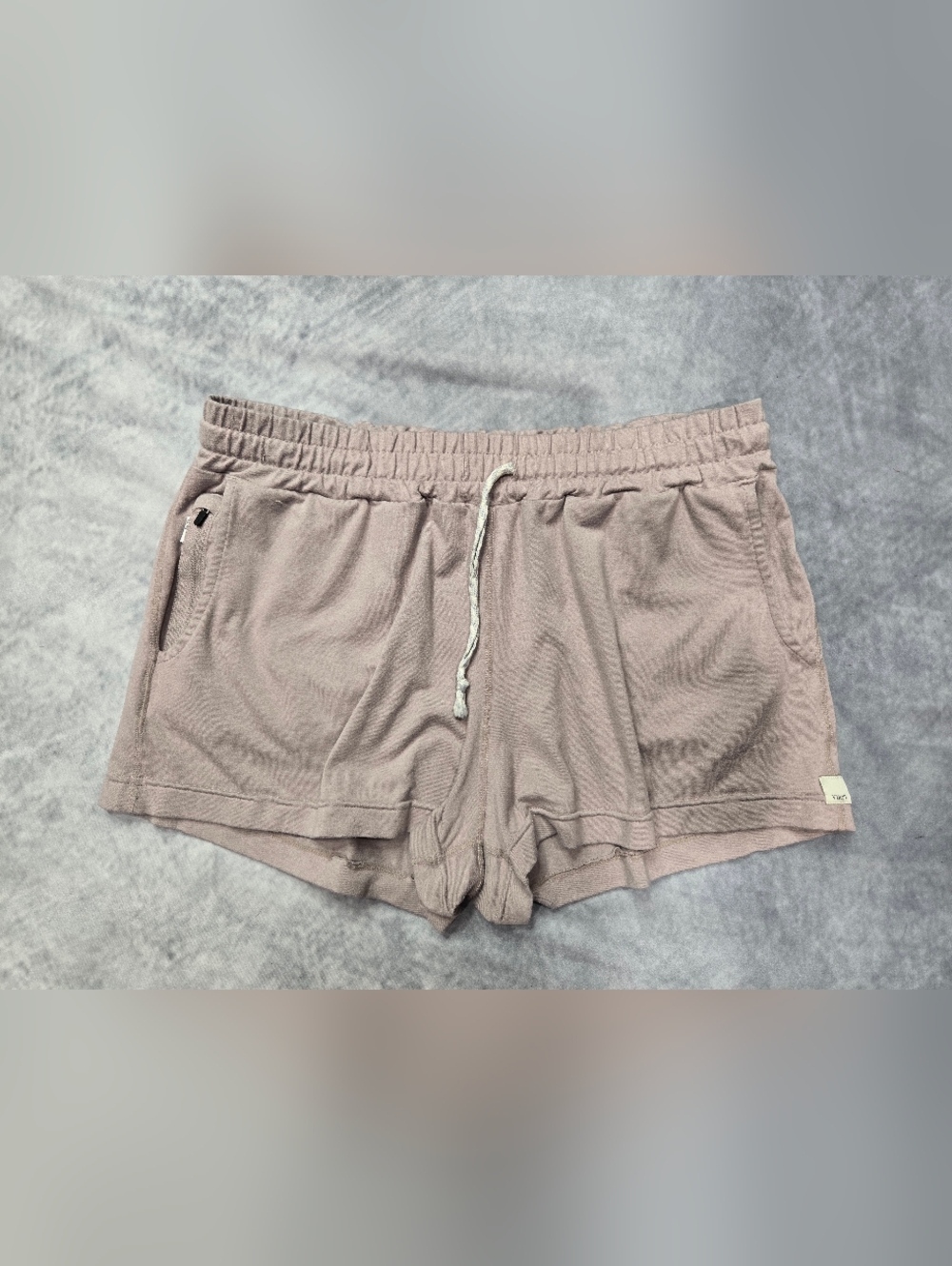 Vuori Halo Performance Shorts in a heathered mauve or dusty pink color